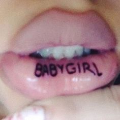 a woman's lips with the word baby girl written on them