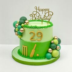 a green and gold birthday cake with the number twenty nine on it's side