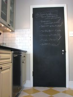 a kitchen with a blackboard on the wall