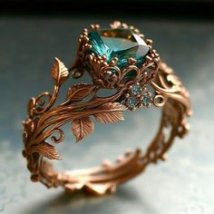 a close up of a ring on a table with leaves and stones in it's center