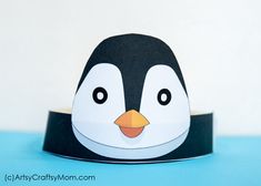 a paper penguin hat sitting on top of a blue table