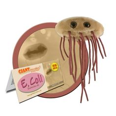 a toy jellyfish on top of a plate next to a pack of gums