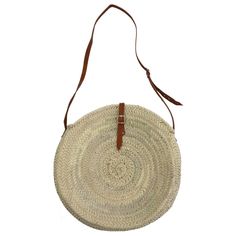 Round basket bag with long shoulder strap and leather closure, the shoulder strap is adjustable. A wonderfully simple shoulder bag and crossbody bag, hand-woven from dried palm leaves in a small family business. Hand-tanned leather from the streets of Marrakech. Dimensions are approximate, as they are handmade: Diameter: approx. 40 cm Depth (widest point): approx. 11 cm Adjustment of carrying strap (carrying height) in the middle of the bag: 36 cm-44 cm Origin: Handmade in Morocco Natural Woven Leather Crossbody Straw Bag, Natural Shoulder Bag With Adjustable Strap For Market, Natural Straw Bag With Leather Handles Crossbody, Market Straw Shoulder Bag With Adjustable Strap, Natural Color Bucket Bag With Adjustable Strap For Market, Summer Market Shoulder Bag With Adjustable Strap, Natural Bucket Bag With Adjustable Strap For Market, Natural Straw Crossbody Bag With Leather Handles, Natural Straw Crossbody Bag With Adjustable Strap