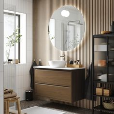 a bathroom with a sink, mirror and shelving unit