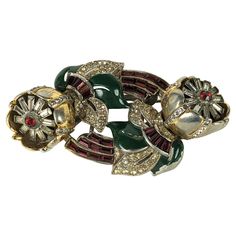 Coro classic flower twist tremblant duette brooch of gilt metal, green enamel, ruby crystal baguettes and crystal pastes. Both flower clips separate off base to be worn separately. 1940's USA. Length 3", Width 1.75". Classic Flower, Ruby Crystal, Flower Clip, Green Enamel, Metallica, Ruby, Twist, Crystals, Flowers