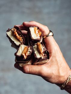 a person holding some kind of food in their hand and it looks like they are eating something