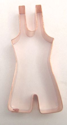 a pink plastic object on a white surface with one piece cut out to look like a baby's bib