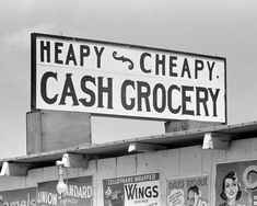 a black and white photo of a cash grocery sign