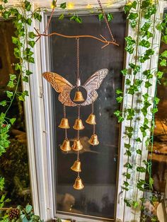 a window decorated with bells and ivy