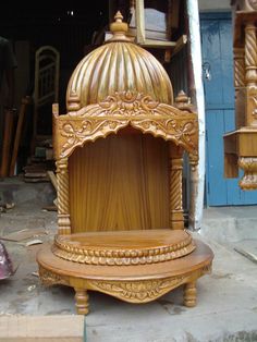 a wooden chair sitting on top of a floor next to a pile of wood furniture