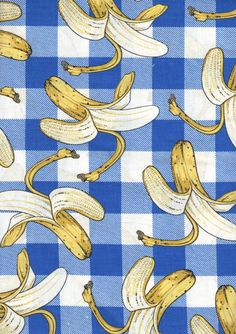 a blue and white checkered table cloth with bananas on it