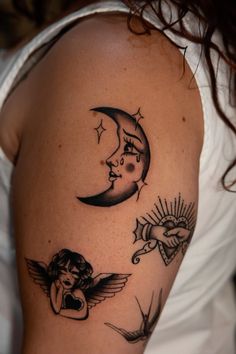 a woman's arm with tattoos on it and an angel sitting next to the moon