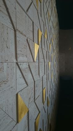 a white wall with gold triangles on it