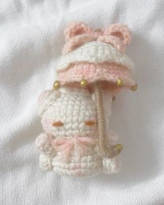 a crocheted stuffed animal with a pink hat