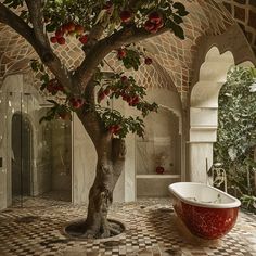 a bathroom with a tree in the middle and a bathtub on the other side