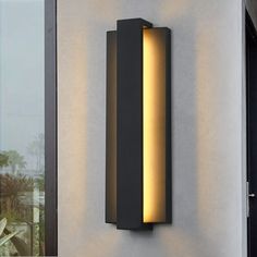 a modern outdoor wall light on the side of a building