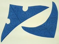 two pieces of blue paper cut into shapes