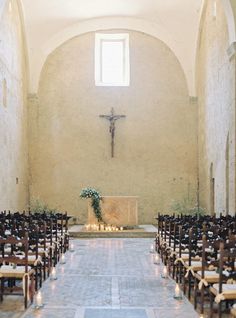 an empty church with pews and candles