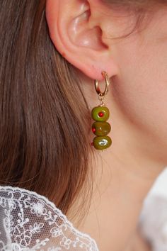 Introducing our Martini Olive earrings! Featuring our brand new Olive charm! <3  Every picnic blanket piece is lovingly designed and handcrafted completely in-house and perfectly finished in our jewellery studio.  Every individual glass feature charm takes around half an hour to delicately form by hand in the flame, reaching temperatures of up to 800 degrees celsius, before heading to the kiln to soak for around 8 hours in the warmth to ensure strength and longevity. The charms are then washed b Handmade Czech Glass Hoop Earrings Gift, Olive Earrings, Olive Jewelry, Martini Olive, Martini Olives, Jewellery Studio, Lampwork Earring, Jewelry Studio, Delicate Jewelry