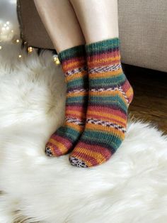 Step into the warm embrace of autumn with our Cozy Harvest Stripe Hand-Knit Socks. These stunning socks are crafted from a luxurious blend of 88% cotton and 12% nylon, offering a perfect balance of softness and durability. The intricate pattern of vibrant stripes captures the rich hues of fall, including deep burgundy, forest green, burnt orange, and golden yellow, making them a stylish addition to your wardrobe. Inspired by the cozy charm of fall, these socks are perfect for those chilly mornin Cozy Winter Socks With Fair Isle Pattern, Cozy Hand Knitted Socks For Fall, Cozy Multicolor Socks For Gifts, Cozy Green Socks For Winter, Cozy Multicolor Socks For Gift, Cozy Multicolor Socks As Gift, Cozy Knitted Socks For Fall, Handmade Cozy Socks For Fall, Cozy Winter Socks For Gifts