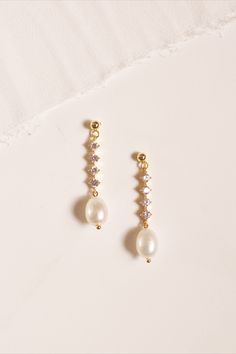 Vintage, yet timeless. The Isla Earring is the perfect blend of the two. These elegant drop earrings feature brilliant zirconia stones, that drop down to accentuate these ivory smooth faux pearls. Styling Tip: Pair with Our Isla Necklace Details: Body Material: 925 Sterling Silver Plating Material: 18k Gold Faux Pearl Stone: Cubic Zirconia Dimensions: approximately 1.5 inches Final Sale Jay Kay, Teardrop Bridal Earrings, Gold Bridal Earrings, Pearl Stone, Bridal Earrings Pearl, Bridal Pearls, Bridal Earrings, Faux Pearl, Bridal Jewelry