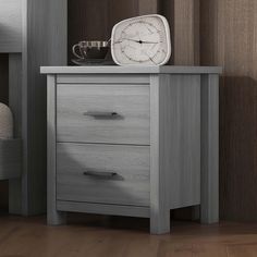 a nightstand with a clock on top of it