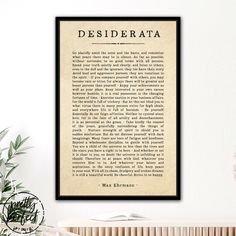 the declaration of desiderrata on parchment paper framed in a black frame next to a potted plant