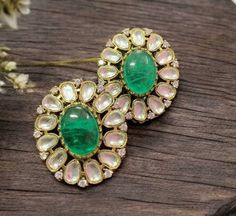 Polki emerald green kundan studs, inspired by Tyaani. Featuring moissanite and diamond accents, these jadau statement earrings capture timeless beauty and sophistication. Perfect for any special occasion, they make a stunning gift, blending traditional craftsmanship with modern luxury for a dazzling finish. *𝐏𝐑𝐎𝐃𝐔𝐂𝐓 𝐃𝐄𝐓𝐀𝐈𝐋* * Material: Brass * Plating: Gold Plated * Stone: Semi Precious Kundan & Polki. *𝐃𝐈𝐒𝐂𝐋𝐀𝐈𝐌𝐄𝐑* Product color may slightly vary due to photographic lighti Green Stone Work Temple Jewelry Earrings, Green Kundan Temple Jewelry Earrings, Green Earrings For Diwali, Green Kundan Earrings With Stone Work, Green Hand Set Earrings For Diwali, Temple Style Emerald Earrings For Festivals, Green Emerald Earrings For Festivals, Emerald Green Earrings For Festivals, Green Jeweled Fusion Earrings