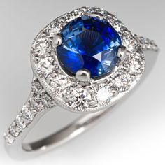 a blue and white ring with diamonds around it