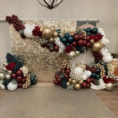 a christmas wreath made out of balloons and ornaments