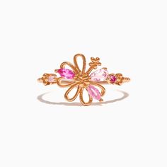 a gold ring with pink stones in the shape of a flower and leaves on it