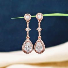 These delicate long Rose Gold Crystal Bridal Earrings features a dangle drop design, making them an ideal choice for both brides and bridesmaids. Made from cubic zirconia, the earrings feature sparkling stones that bring elegance to any wedding ensemble. With a length of approximately 1.26 inches and teardrop dimensions of 0.47 H x 0.39 W inches, these minimalist long teardrop earrings are hypoallergenic, guaranteeing comfort for all wearers. They also serve as a thoughtful gift for bridesmaids and are a beautiful addition to any wedding jewelry collection. ✨ Specifications: Earring Length: approximately 1.26 inches Bottom Teardrop Size: 0.47 H x 0.39 W inches Any questions? Please feel free to contact me. Minimalist Wedding Jewelry, Drop Bridal Earrings, Earrings For Bride, Brides Mom, Crystal Bridal Earrings, Bridal Earrings Drop, Rose Gold Crystal, Wedding Jewellery Collection, Drop Design