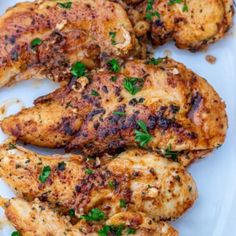 grilled chicken with herbs on a white plate