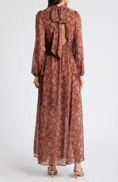 Be endlessly enchanting in the flowery chiffon maxi designed with floaty cascading ruffles and a shaping smocked waist. 58" length Adjustable back-tie closure Mock neck Long sleeves Smocked waist Partially lined 100% polyester Dry clean or hand wash, line dry Imported Fall Maxi Dress With Ruffles And V-neck, Flowy Brown Floral Print Maxi Dress, High-end Floral Print Long Sleeve Dress For Fall, Fall Floral Print Button-up Maxi Dress, Brown Floral Print V-neck Maxi Dress, Maxi Design, Cascading Ruffles, Chiffon Maxi, Long Sleeve Maxi