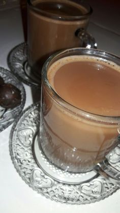 two glasses of hot chocolate drink on a plate