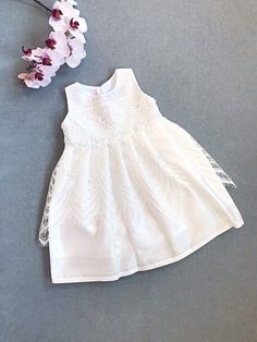 Silk dupioni dress and white organic cotton lining baby girl's christening/ baptism gown. Sleeveless, 3 pearl buttons closure at the back. Accented with off white lace on the chest and eyelash delicate lace on the skirt.  Available in sizes from 0 months to 5 years old.  Matching accessories can be made upon request, sold separately. Designer fabric organic cotton from USA. Handmade in Canada. Processed/made within 3-5 business days, shipping takes 7-10 business days regular mail. Express delive Elegant First Communion Dress For Summer, First Communion Lace Patchwork Dress For Spring, First Communion Spring Dress With Lace Patchwork, Spring First Communion Dress With Lace Patchwork, Lace Dress For First Communion In Summer, White Lace Dress For Baptism In Spring, White Lace Dress For Spring Baptism, Elegant Spring Baptism Dress, Elegant Summer First Communion Dress