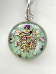 a glass pendant with flowers on it