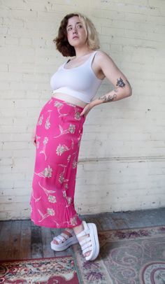 "Late 1990s pink floral maxi/midi skirt made by 'Chaus Sport'. Side zipper and two button closure. Lightweight and breezy, perfect for styling for multiple seasons! Marked women's size small, please see full measurements below.  Very good to excellent vintage condition with no stains or issues of note.  Measurements (taken flat): Waist: 14\" Hips: 21\" Length: 33\" Model is 5' 7\" and wears 27.5\" waist/ 39\" hips" Skirt Flowers Outfits, Pink Fitted Bottoms 90s Style, Pink Floral Print Maxi Skirt For Day Out, 90s High Waist Pink Bottoms, Pink High Waist 90s Bottoms, Fitted Pink Floral Maxi Skirt, Pink Floral Print Long Skirt, Fitted Pink Floral Print Maxi Skirt, Vintage Long Pink Skirt