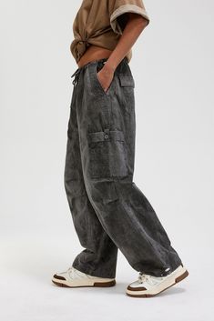 The Washed Multi-Pocket Crinkled Cargo Pants seamlessly blend avant-garde style with meticulous craftsmanship. These cargo pants feature a washed and distressed finish for a rugged, vintage look. Designed with multiple pockets, including large pockets on each knee, these pants provide ample storage and a distinctive appearance. The crinkled detailing at the knees adds texture and visual interest, while the adjustable drawstring cuffs ensure a customizable fit. Made from premium 100% cotton fabri Casual Baggy Distressed Cargo Pants, Casual Acid Wash Pants With Pockets, Baggy Grunge Bottoms With Multiple Pockets, Relaxed Fit Grunge Bottoms With Pockets, Grunge Washed Pants For Streetwear, Washed Black Wide Leg Pants, Casual Acid Wash Cargo Pants With Pockets, Baggy Distressed Washed Black Pants, Washed Black Grunge Bottoms With Pockets