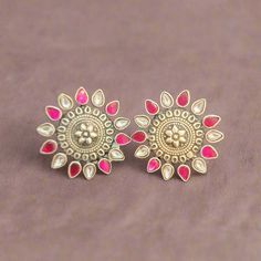 Add a touch of vintage charm to your look with these Oxidized Studs. Featuring a floral design with pink and white kundans, these studs are perfect for making a stylish statement. Ideal for both casual and festive occasions, they bring a blend of traditional and contemporary elegance to any outfit. Material: 92.5 oxidized silver Stones: Semi precious kundans Festive Gota Work Earrings For Designer Wear, Festive Designer Gota Work Earrings, Festive Pink Jewelry With Dori Work, Traditional Pink Jewelry With Dori Work, Festive Pink Zari Work Jewelry, Festive Pink Jewelry With Zari Work, Pink Meenakari Temple Jewelry Earrings, Pink Meenakari Temple Earrings, Pink Temple Jewelry Earrings For Festive Occasions