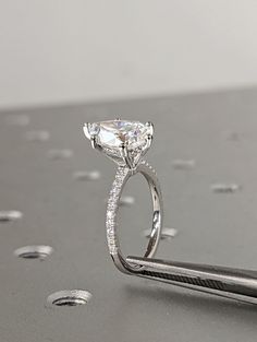 a close up of a diamond ring on a table