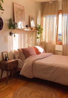 a bed room with a neatly made bed next to a window and potted plants