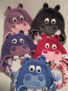 six crocheted hats with different colored animals on them