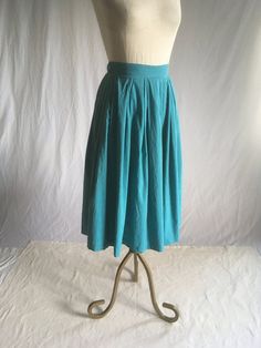 "vintage 1950s skirt handmade blue cotton feel pleated waist side zip w/button top good vintage condition w/light wear, zipper missing teeth but works -see photos small patch repair (by me) to waist band under button tiny hole repairs w/underside patches (by me)-see photos (close up pictures washed out true color) measures, lying flat, waist-12 1/2\" to 13\" w/a tug length-28\"" Retro Blue Cotton Skirt, Blue A-line Cotton Skirt, Retro Fitted Cotton Pleated Skirt, Blue Cotton Lined Pleated Skirt, Cotton Accordion Pleated Skirt, Vintage Blue Skirt With Pockets, Blue Vintage Skirt With Pockets, Vintage Cotton Pleated Skirt, Vintage Pleated Cotton Skirt