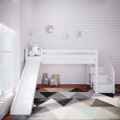 there is a white bunk bed with a slide in the room