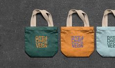 three bags with the words batang vegan on them are lined up against a wall