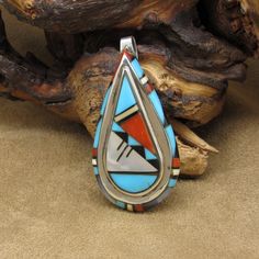 Sterling silver inlaid teardrop pendant. The pendant is signed by Lena Tsethlikai Zuni. The pendant is 2 1/8" tall x 1 1/16" wide. There are genuine mother-of-pearl and faux or block stones used in the inlay. The pendant is in good condition. Thank you for shopping in our store. Please let us know if you have questions.  MS-22 k *The color you see on your screen may not reflect the actual stone color due to variations in monitors* Boulder Opal Pendant, Zuni Jewelry, Teardrop Pendant, Tube Beads, Opal Pendants, Opal Necklace, American Jewelry, Drop Pendant, Beaded Dangles