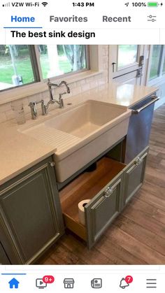 a kitchen sink with an open drawer in the middle and a window to the side