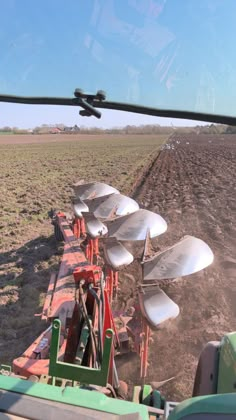 a row of satellite dishes sitting on top of a field