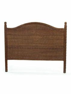 a brown wicker bed frame with headboard and foot board